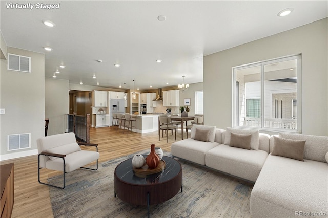 17196 W 92nd Loop, Arvada, CO 80007 - living room featuring light wood-style floors, recessed lighting, and baseboards