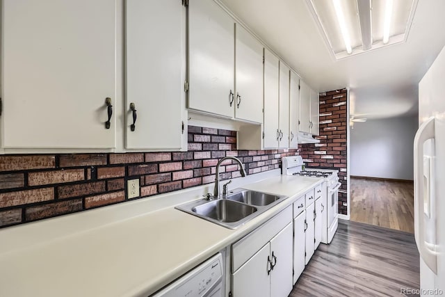 kitchen with sink, white appliances, light hardwood / wood-style flooring, and white cabinets