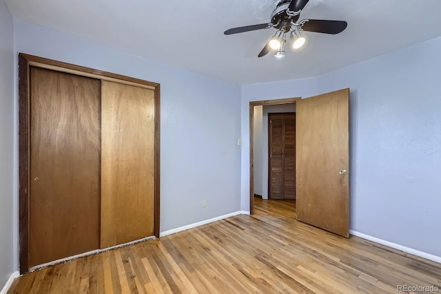 unfurnished bedroom with light hardwood / wood-style flooring, a closet, and ceiling fan