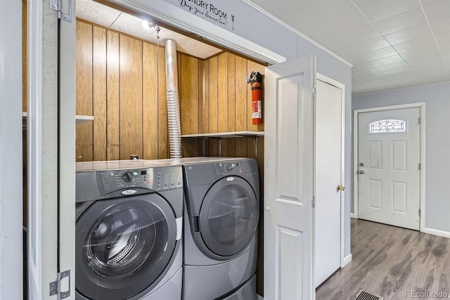 laundry room featuring hardwood / wood-style floors and washing machine and clothes dryer