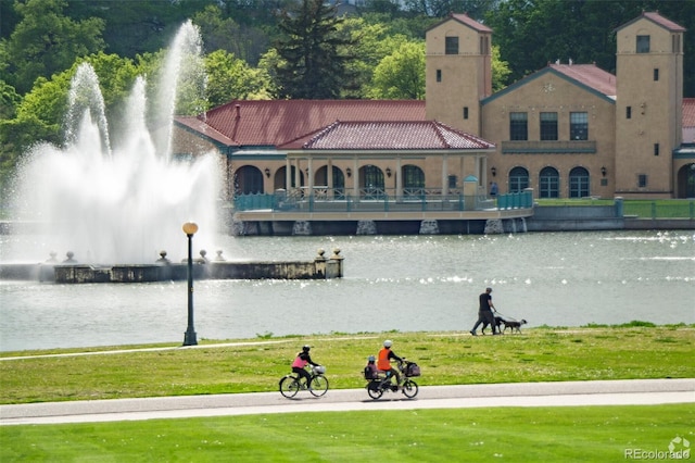 exterior space featuring a water view and a lawn