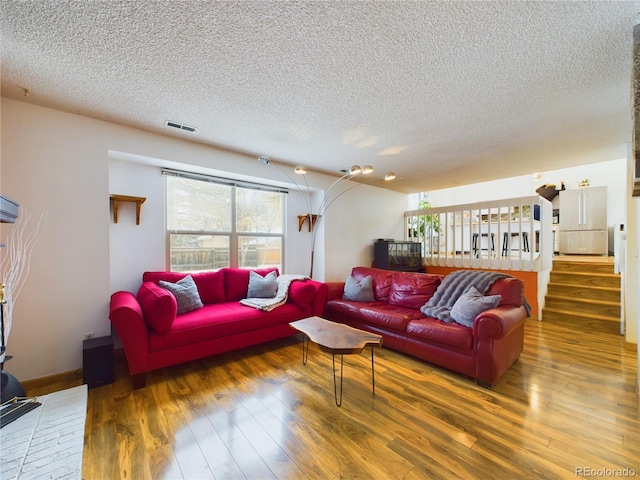 living room with dark hardwood / wood-style floors and a textured ceiling