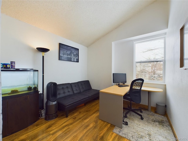 office area with lofted ceiling, dark hardwood / wood-style flooring, and a textured ceiling