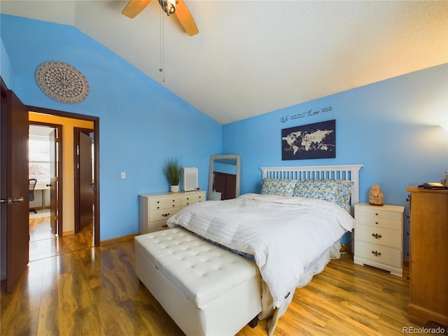 bedroom with vaulted ceiling, ceiling fan, and dark hardwood / wood-style flooring