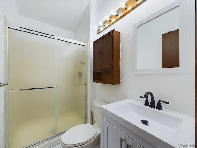 bathroom with vanity, toilet, and a shower with door