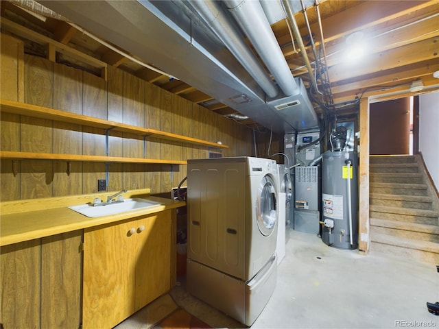 washroom with washer / clothes dryer, sink, and water heater