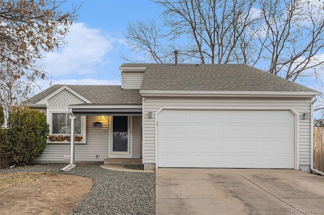 ranch-style home featuring an attached garage, driveway, and roof with shingles