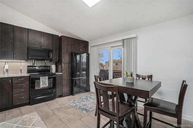 kitchen featuring lofted ceiling, dark brown cabinetry, black appliances, and light stone countertops