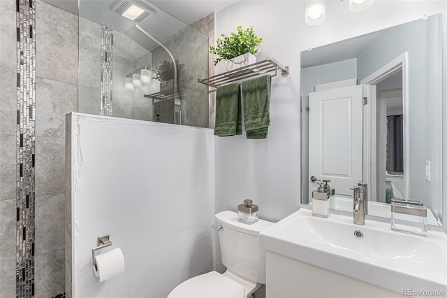 bathroom featuring visible vents, toilet, vanity, and walk in shower