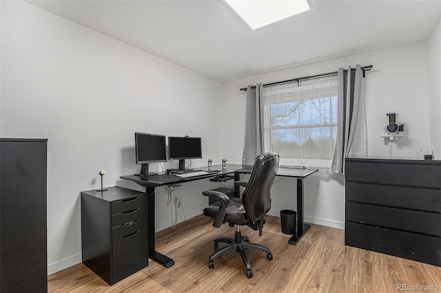 office area with baseboards and wood finished floors