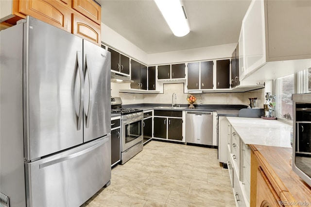 kitchen featuring sink, appliances with stainless steel finishes, and butcher block counters