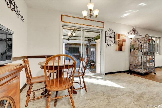 dining area with a notable chandelier and light wood-type flooring