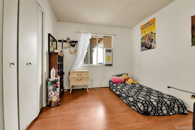 bedroom featuring a textured ceiling and light wood-type flooring