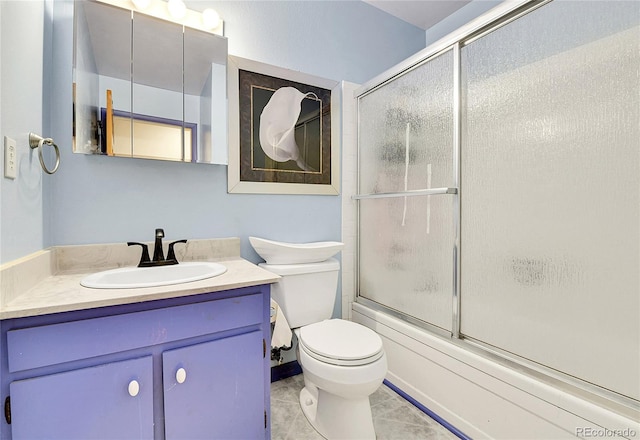 full bathroom with vanity, shower / bath combination with glass door, toilet, and tile patterned floors