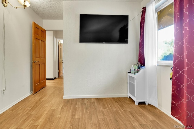 interior space with light hardwood / wood-style flooring and a textured ceiling