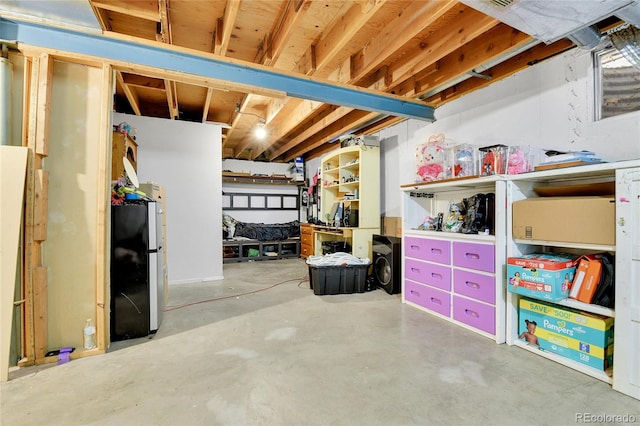 basement with stainless steel refrigerator