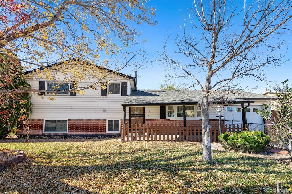 split level home featuring a porch and a front yard