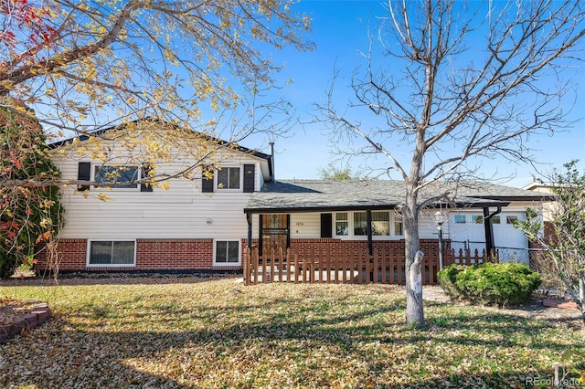 split level home featuring a porch and a front yard