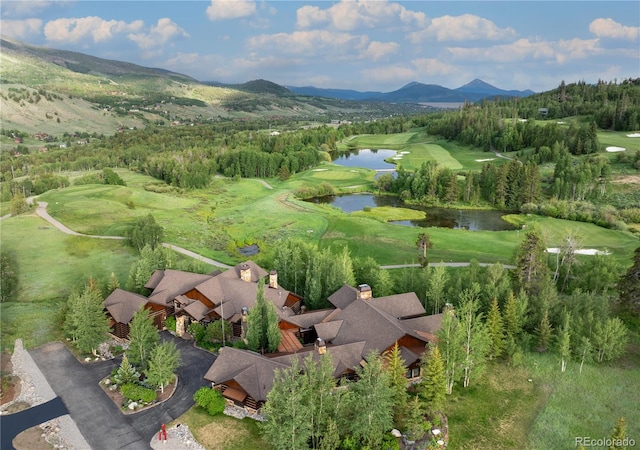 drone / aerial view featuring a water and mountain view