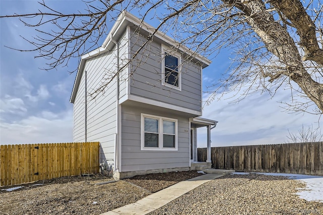 view of side of home with fence