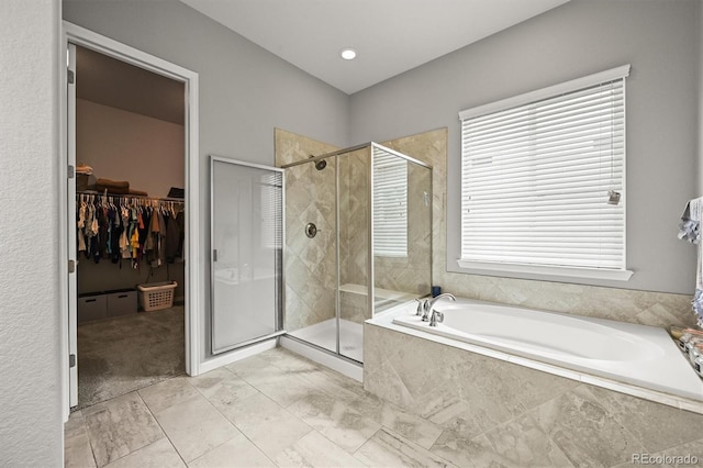 16256 Ute Peak Way, Broomfield, CO 80023 - bathroom featuring a garden tub, a shower stall, and a spacious closet
