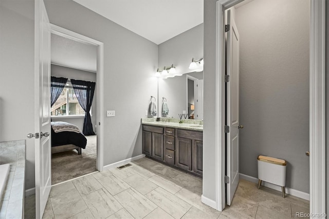 16256 Ute Peak Way, Broomfield, CO 80023 - ensuite bathroom featuring double vanity and baseboards