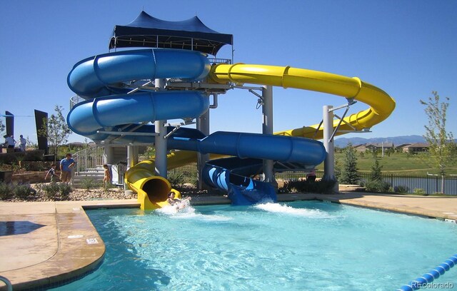 16256 Ute Peak Way, Broomfield, CO 80023 - community pool with a water slide, a mountain view, and a water play area