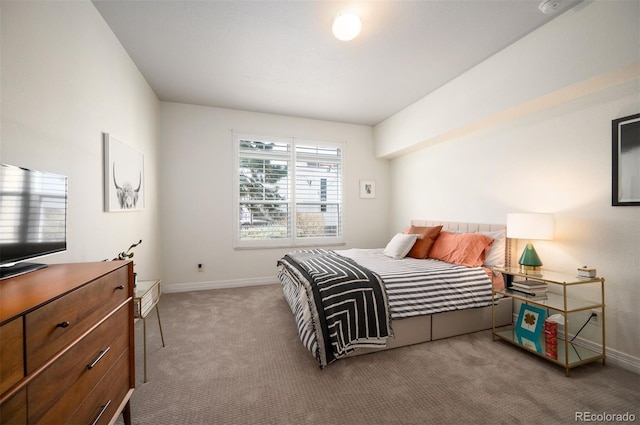 bedroom with baseboards and carpet