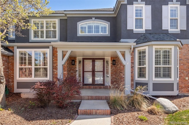 404 Yarrow Pl, Castle Pines, CO 80108 - view of front of property featuring covered porch, stucco siding, and brick siding