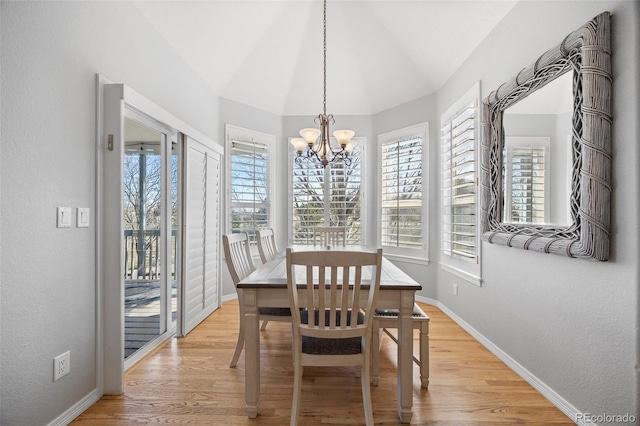 404 Yarrow Pl, Castle Pines, CO 80108 - dining space with a chandelier, baseboards, light wood finished floors, and lofted ceiling