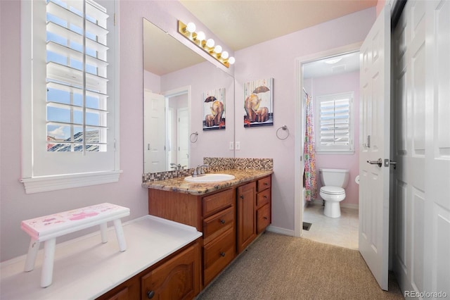 404 Yarrow Pl, Castle Pines, CO 80108 - bathroom with toilet, vanity, baseboards, a shower with shower curtain, and tile patterned floors
