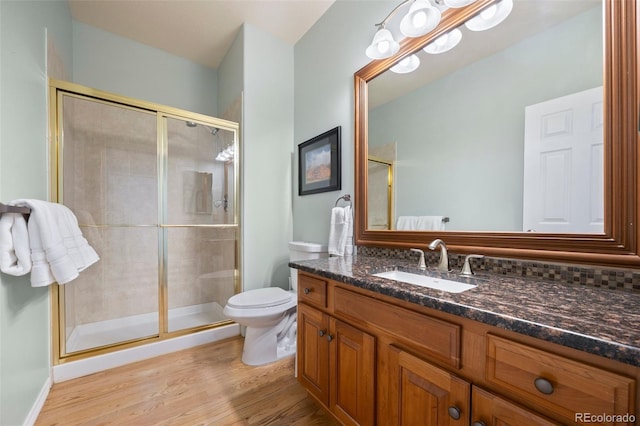 404 Yarrow Pl, Castle Pines, CO 80108 - full bath featuring a stall shower, wood finished floors, toilet, and vanity