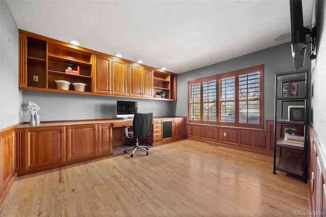 404 Yarrow Pl, Castle Pines, CO 80108 - office space with built in study area, light wood-type flooring, wainscoting, recessed lighting, and wooden walls