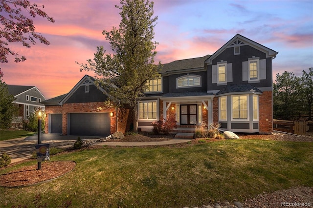 404 Yarrow Pl, Castle Pines, CO 80108 - traditional home featuring brick siding, an attached garage, a front yard, and concrete driveway