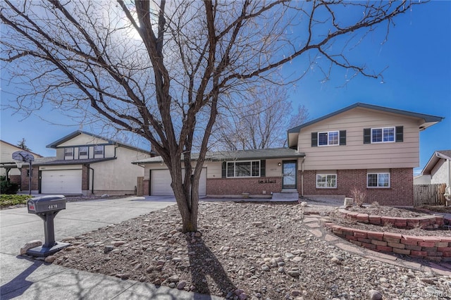 tri-level home featuring brick siding, driveway, and an attached garage