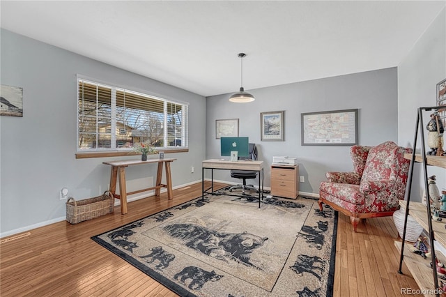 home office featuring baseboards and hardwood / wood-style floors