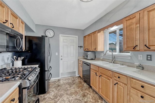 kitchen featuring gas stove, baseboards, a sink, light countertops, and stainless steel dishwasher