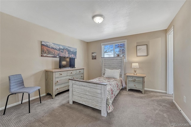 carpeted bedroom featuring baseboards