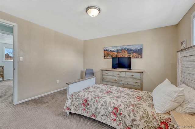 bedroom with baseboards and carpet