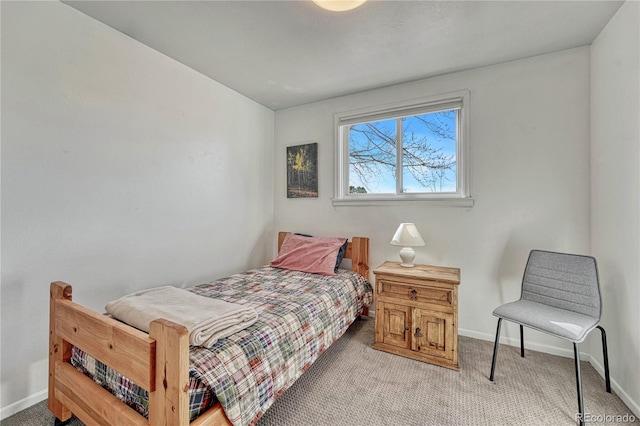 bedroom featuring baseboards and light colored carpet