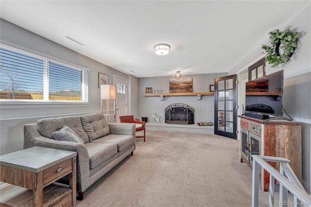 carpeted living area featuring a fireplace and visible vents