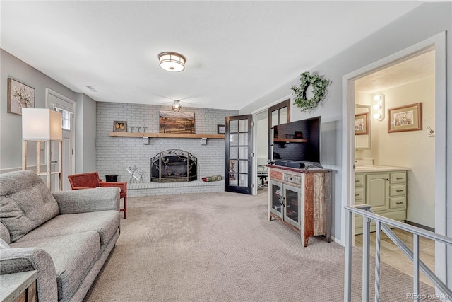 living room with light carpet and a fireplace