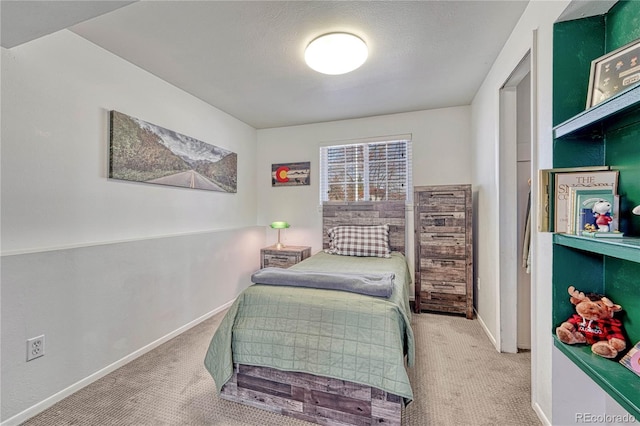 carpeted bedroom with baseboards