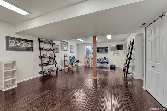 workout room featuring wood finished floors, visible vents, and baseboards