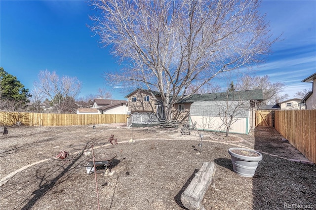 view of yard featuring an outdoor structure and a fenced backyard