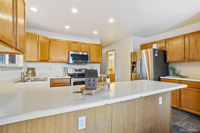 kitchen featuring kitchen peninsula, sink, and stainless steel appliances