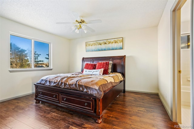 bedroom with ensuite bath, ceiling fan, dark wood-type flooring, and a textured ceiling