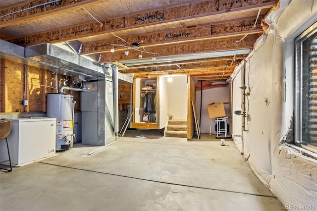 basement with water heater and white fridge