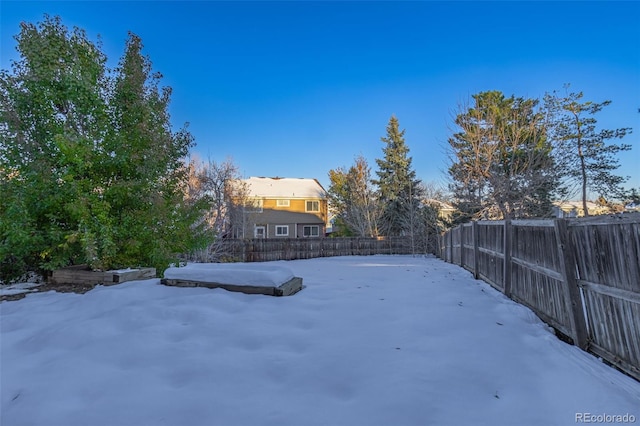 view of yard layered in snow