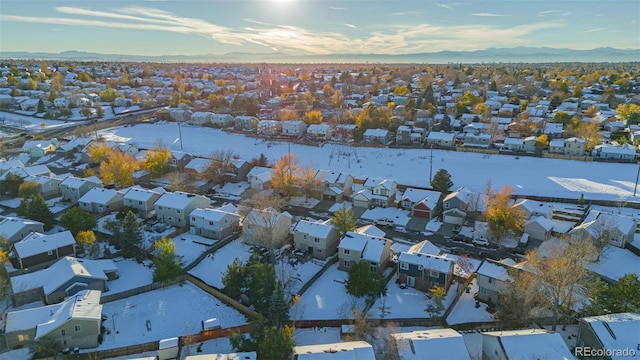 snowy aerial view featuring a mountain view